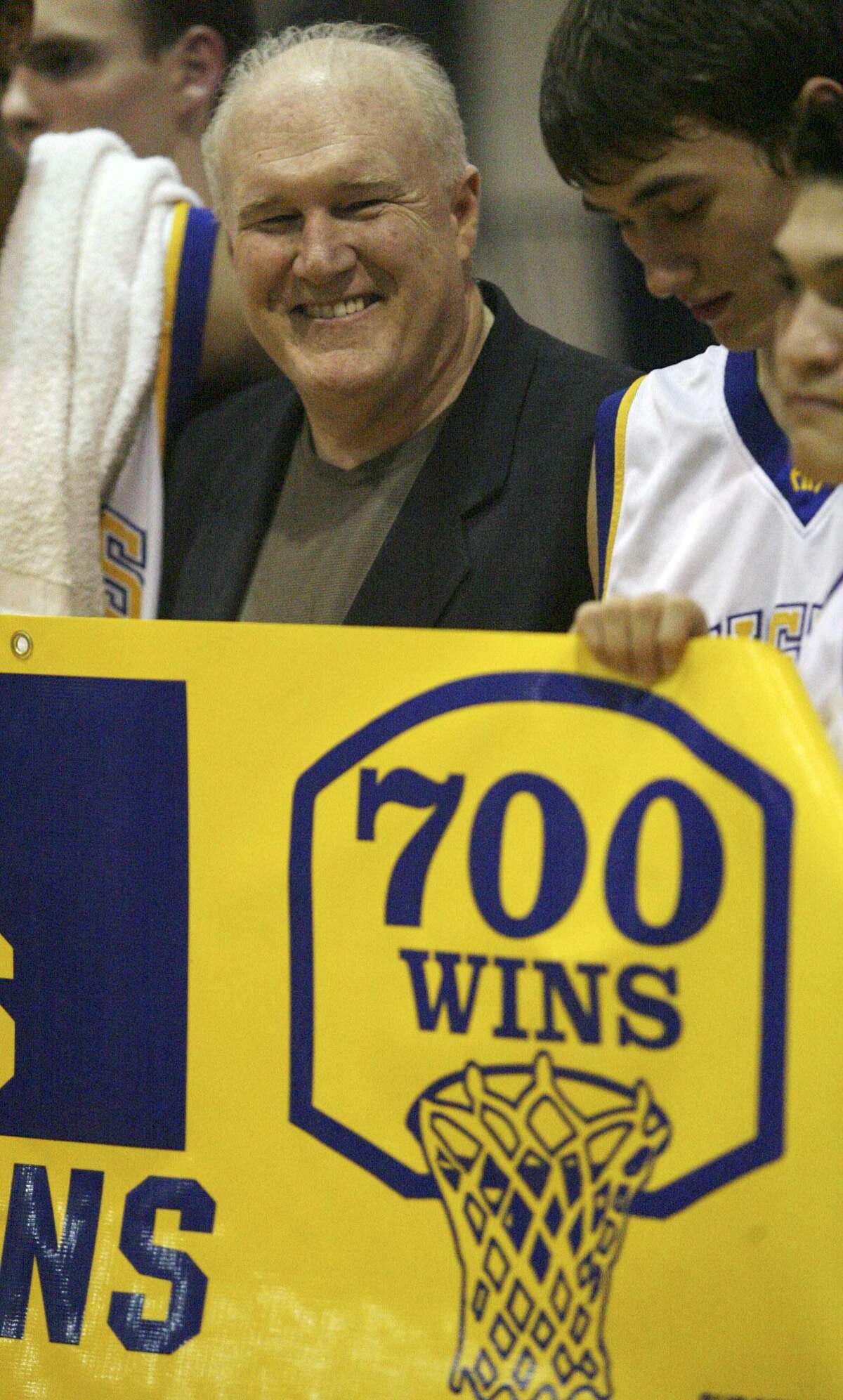 Alamo Heights players surround coach Charlie Boggess after his 700th career win, coming against Fox Tech, in 2007.
