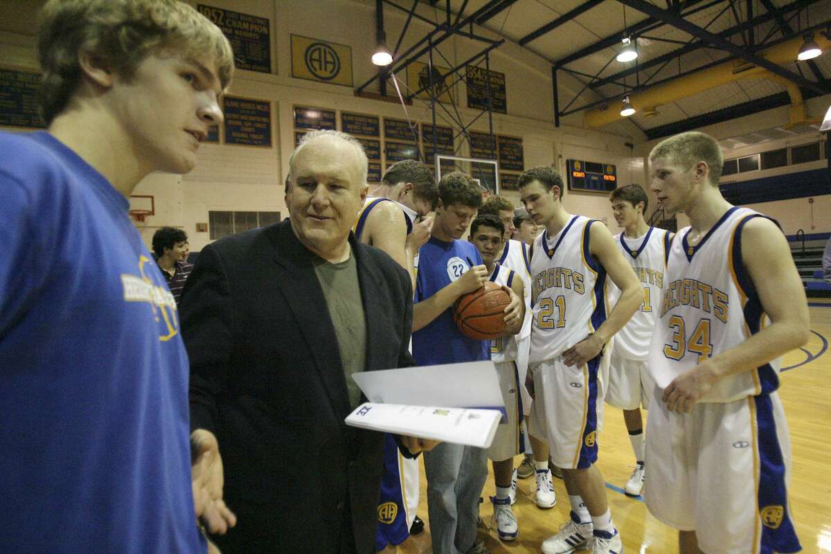 Alamo Heights players sign the winning basketball after the 700th career win for coach Charlie Boggess in 2007.