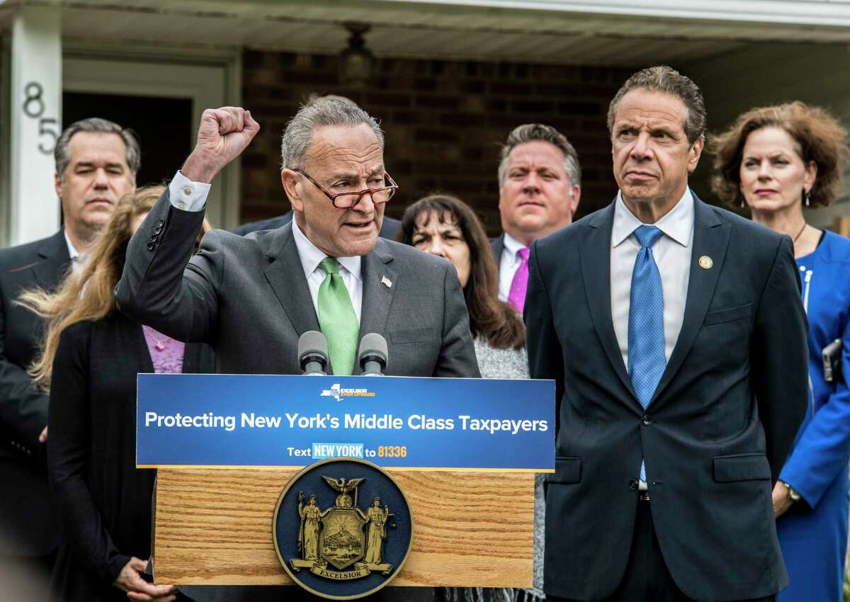 Sen. Charles Schumer, left, and Gov. Andrew Cuomo joined forces on the front lawn of 85 University Street on Monday, Oct. 23, 2017, to call on New York Representatives to protect middle-class homeowners by opposing repeal of State and Local Tax deductions and any tax bill that proposes it at a press conference held in Bethlehem, N.Y. (Skip Dickstein/Times Union)