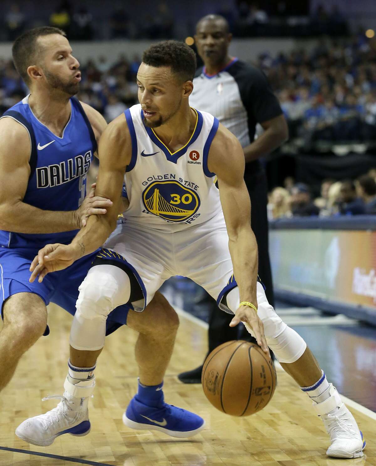 Golden State Warriors guard Stephen Curry (30) drives against Dallas Mavericks guard J.J. Barea (5) during the first half of an NBA basketball game in Dallas, Monday, Oct. 23, 2017.