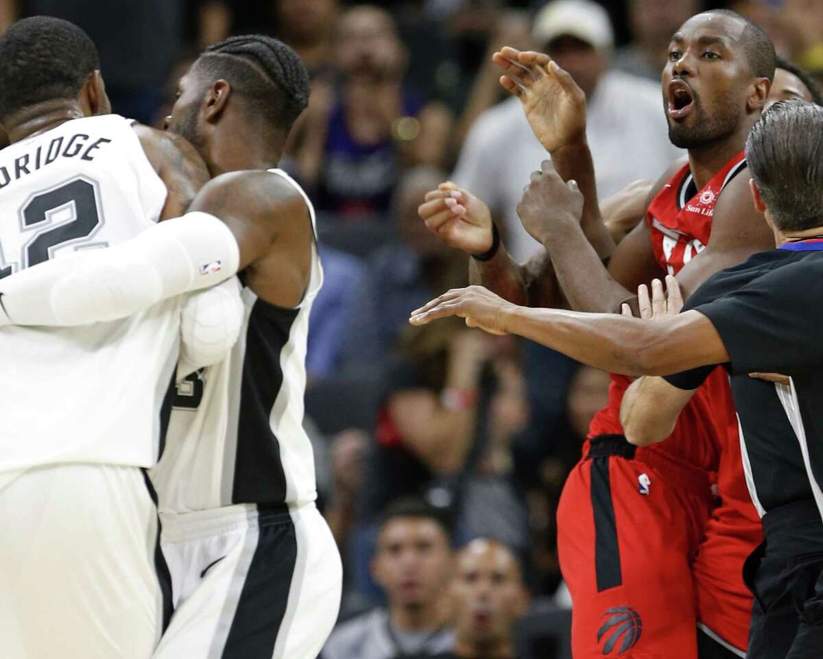 San Antonio SpursÕ LaMarcus Aldridge (left) and Toronto RaptorsÕ Serge Ibaka are separated after shoving each other during second half action Monday Oct. 23, 2017 at the AT&T Center. Aldridge and Ibaka received technicals on the play. The Spurs won 101-97.