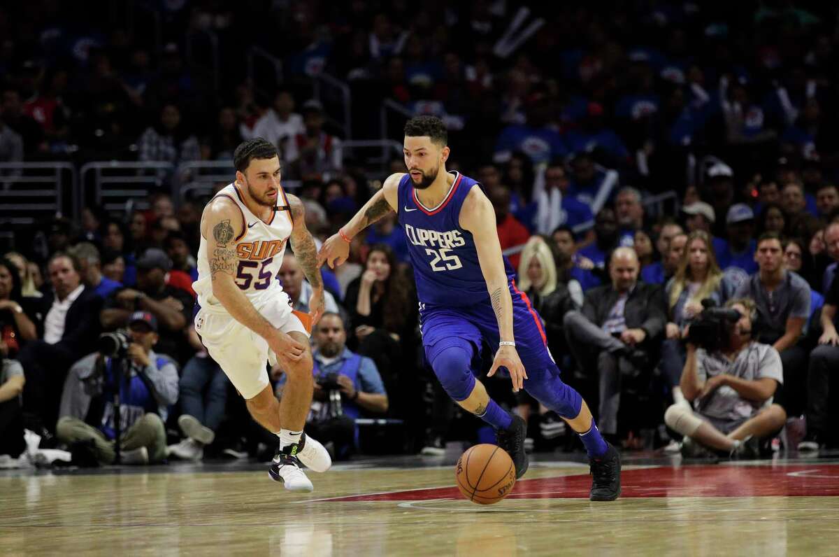 Los Angeles Clippers' Austin Rivers drives past Phoenix Suns' Mike James during the second half of an NBA basketball game Sunday, Oct. 22, 2017, in Los Angeles. (AP Photo/Jae C. Hong)