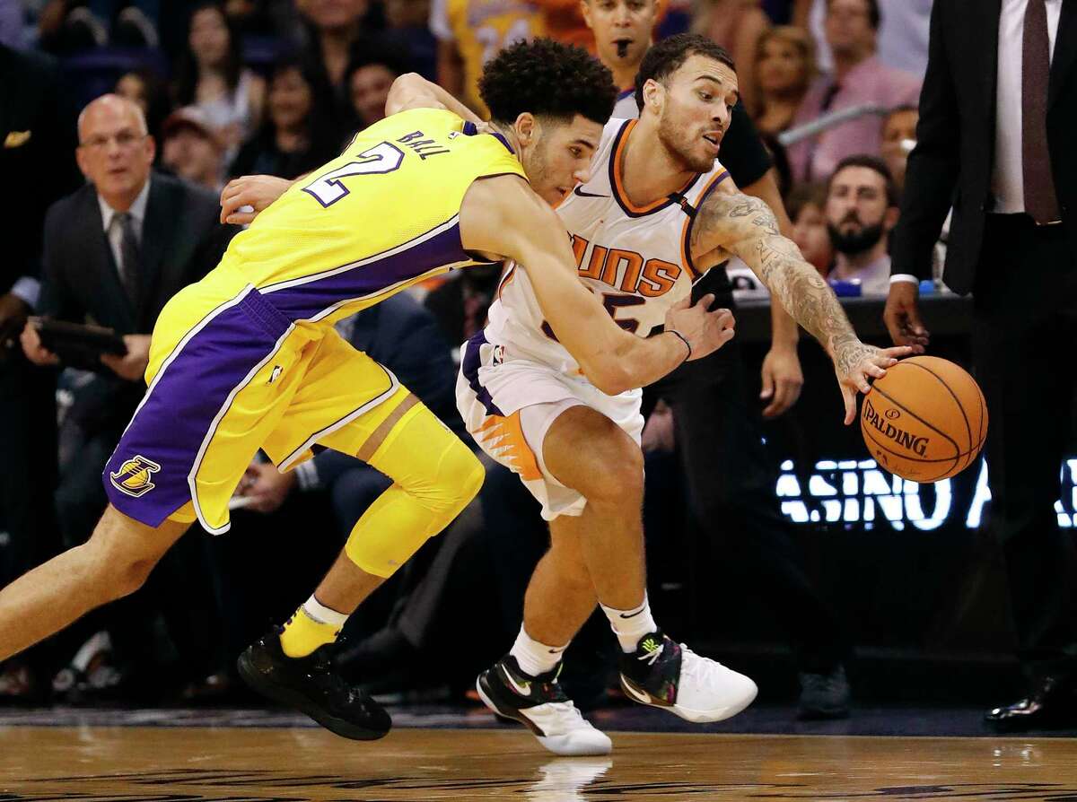 Phoenix Suns guard Mike James steals the ball from Los Angeles Lakers guard Lonzo Ball (2) during the second half of an NBA basketball game, Friday, Oct. 20, 2017, in Phoenix. (AP Photo/Matt York)