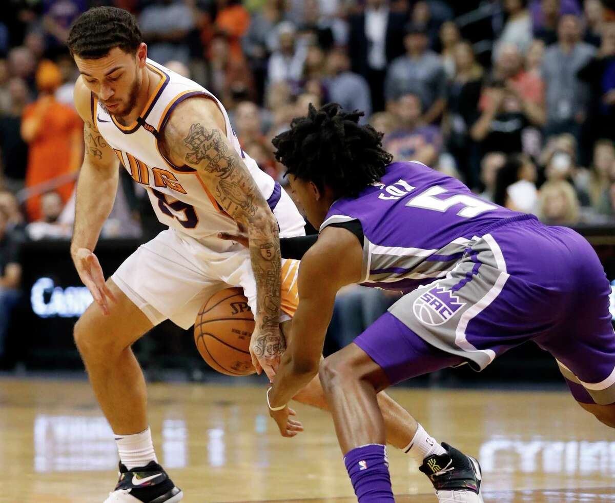 Phoenix Suns guard Mike James (55) has the ball knocked loose by Sacramento Kings guard De'Aaron Fox (5) during the second half of an NBA basketball game, Monday, Oct. 23, 2017, in Phoenix. The Suns won 117-115. (AP Photo/Matt York)