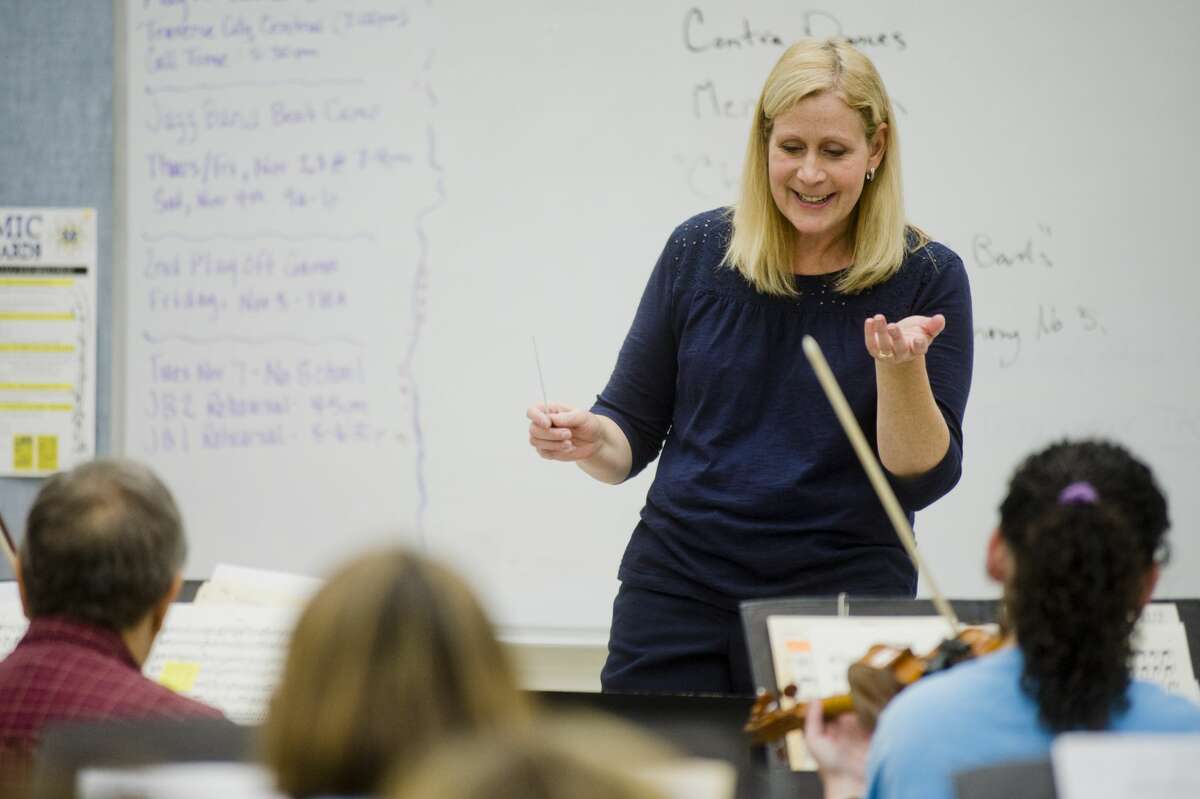 Gina Provenzano conducts the Midland Community Orchestra during a rehearsal on Monday, Oct. 23, 2017 at Midland High School. (Katy Kildee/kkildee@mdn.net)