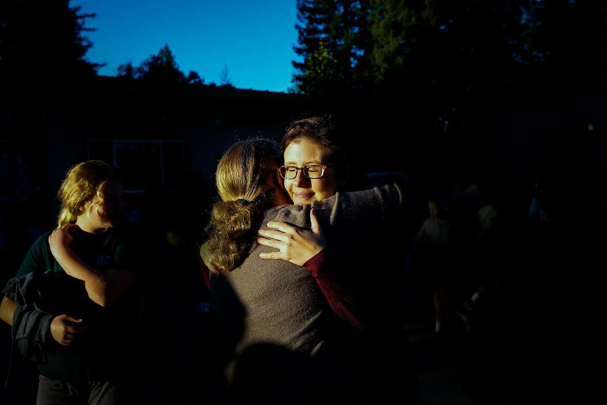 Teacher and mother Jennifer Freese (right) is embraced by a teacher on her first day back at work since her home was destroyed in the Tubbs fire in Healdsburg, Calif., on Tuesday, Oct. 24, 2017. The Freese family lost their home in the Tubbs fire and have been living in a house that was lent to them by a friend of their church. Jennifer and her husband Sean also lost their home in Hurricane Katrina when they were living in New Orleans.