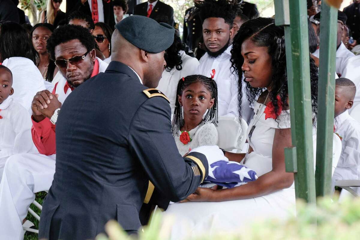 Myeshia Johnson Friday as she is presented with a folded US flag by a military honor guard member during the burial service for her husband US Army Sgt. La David Johnson at the Memorial Gardens East cemetery in Hollywood, Florida. The president’s words following a call to the widow demonstrated anew his penchant for lying.