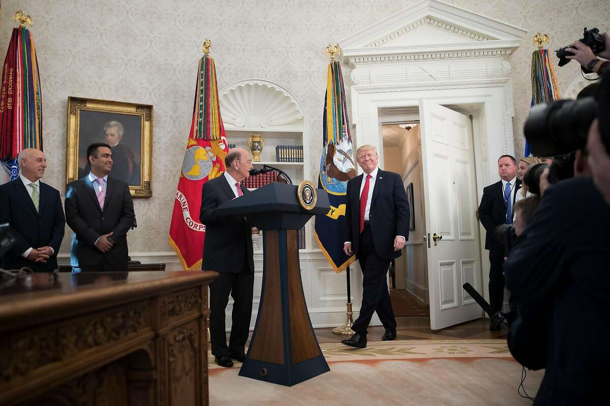President Donald Trump participates in the Minority Enterprise Development Week awards ceremony in the Oval Office of the White House in Washington, Oct. 24, 2017. Trump started his day on Tuesday with renewed attacks on Sen. Bob Corker, chastising him for his skepticism over a $1.5 trillion tax cut. At center is Commerce Secretary Wilbur Ross. (Tom Brenner/The New York Times)