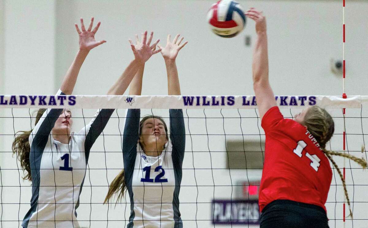 Willis' Makayla Bane (1) and Jaiden Kay (12) challenge a shot by Tomball's Kendall Glueck (14) during the first set of a District 20-5A high school volleyball match at Willis High School, Tuesday, Oct. 24, 2017, in Willis.