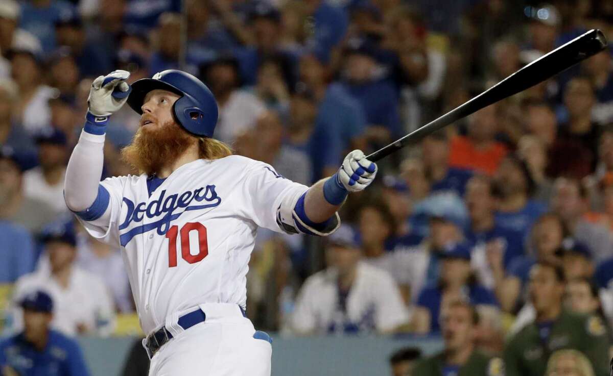 Los Angeles Dodgers' Justin Turner watches his two-run home run against the Houston Astros during the sixth inning of Game 1 of baseball's World Series Tuesday, Oct. 24, 2017, in Los Angeles. (AP Photo/Matt Slocum)