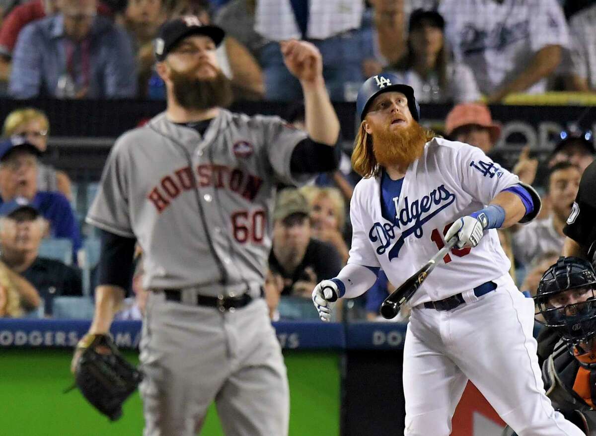 Los Angeles Dodgers' Justin Turner watches his two-run home run off Houston Astros starting pitcher Dallas Keuchel during the sixth inning of Game 1 of baseball's World Series Tuesday, Oct. 24, 2017, in Los Angeles. (AP Photo/Mark J. Terrill)