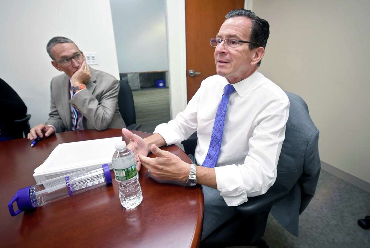 Gov. Dannel P. Malloy’s warning to legislative leaders not to raid the state’s clean energy funds has made the lawmakers rethink their plans, heading into Wednesday night’s scheduled debate in the Senate on a new budget. In a file photo, the governor is shown with his budget chief, Ben Barnes, left, secretary of the Office of Policy and Management.