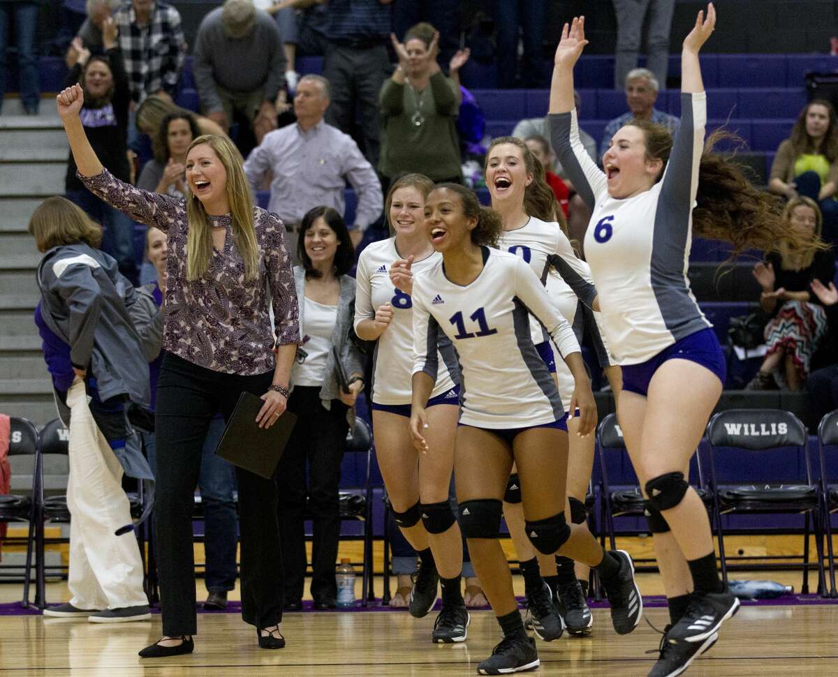 Willis head coach Megan Storms celebrates with the rest of the team after defeating Tomball during a high school volleyball match to end the regular season as co-District 20-5A champions at Willis High School, Tuesday, Oct. 24, 2017, in Willis.