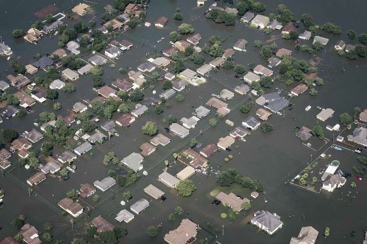 Floodwater surrounds homes in Beaumont, Texas, about 70 miles east-northeast of Houston, Aug. 31, 2017. With most roads in and out of the area under water, and the Neches River still rising, federal officials are trying to get enough bottled water into Beaumont to prevent a health crisis. (Alyssa Schukar/The New York Times)