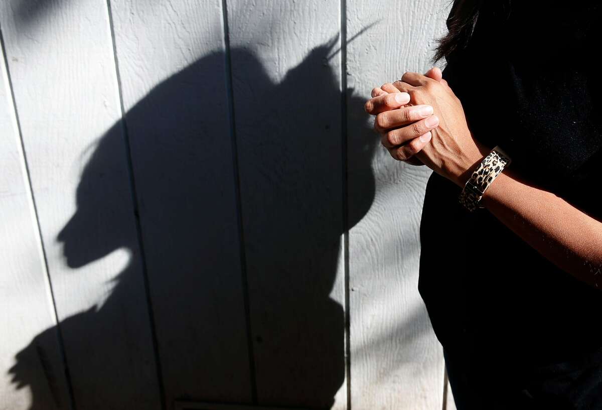 Alicia, who doesn't to reveal her last name, casts a shadow at a family member's home in Sonoma, Calif. on Wednesday Oct. 25, 2017. Many undocumented residents affected by the wildfires are reluctant to file for FEMA claims fearing their status may be passed on to the Department of Homeland Security.