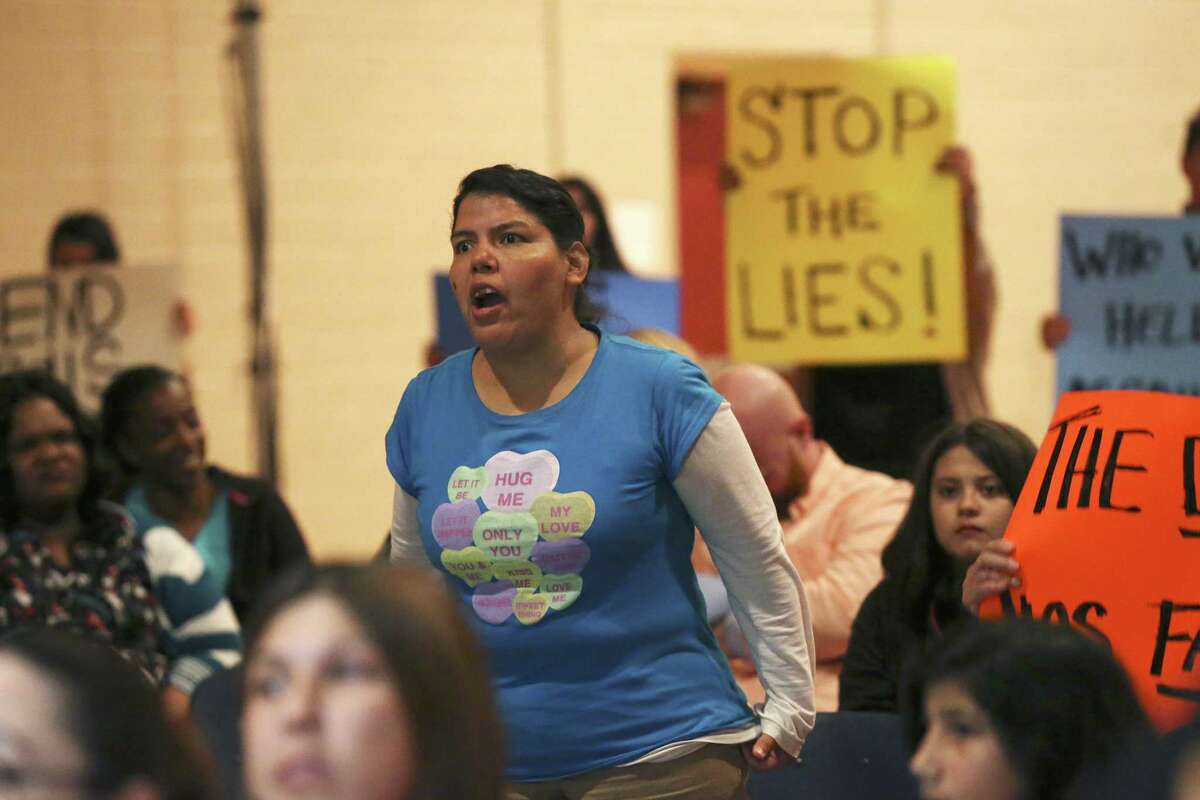 Annette Hernandez objects to a student not allowed to speak as parents and students give their comments to board members of the San Antonio School for Inquiry & Creativity, (SASIC) last February. The Texas Education Agency closed the charter district in August.