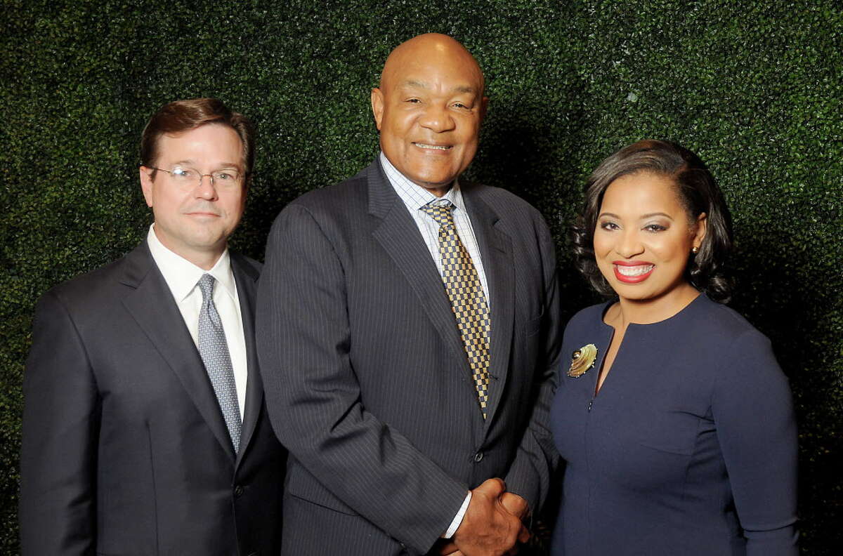 Honoree George Foreman with chairs Champ Warren,at left, and Shawntell McWilliams at the Fifth Ward Enrichment Program's "Changing Men, Changing Lives" luncheon at the Junior League of Houston honoring George Foreman Wednesday Oct. 25, 2017.(Dave Rossman Photo)