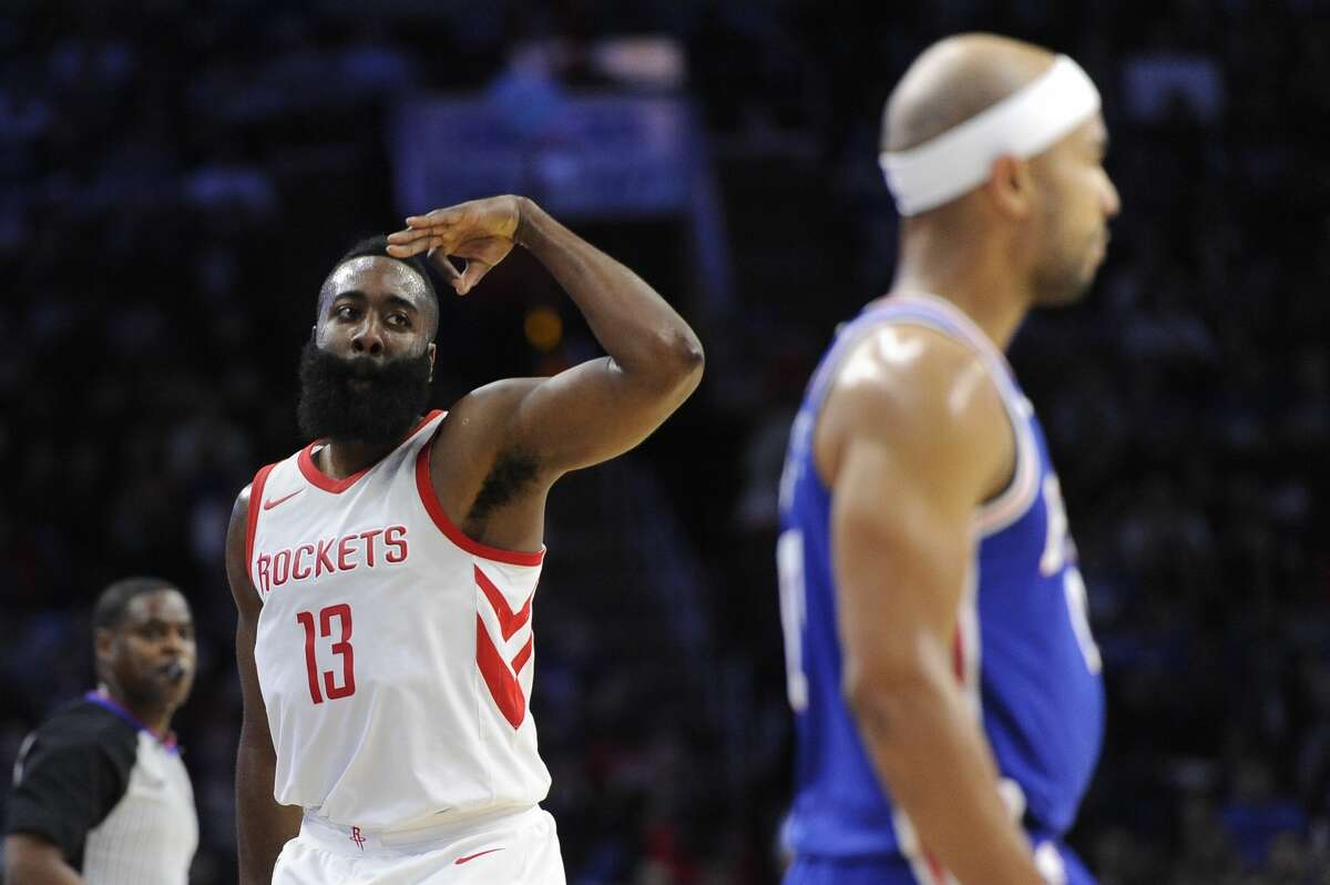 Houston Rockets' James Harden (13) gestures near Philadelphia 76ers' Jerryd Bayless after scoring a basket in the first half of an NBA basketball game, Wednesday, Oct. 25, 2017, in Philadelphia. The Rockets won 105-104. (AP Photo/Michael Perez)