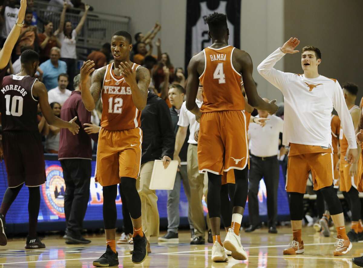 Texas Longhorns forward Mohamed Bamba (4) and guard Kerwin Roach II (12) celebrate after the exhibition basketball game between the Texas Longhorns and the Texas A&M Aggies to benefit the Rebuild Texas Relief Fund at Tudor Fieldhouse in Houston, TX on Wednesday, October 25, 2017.