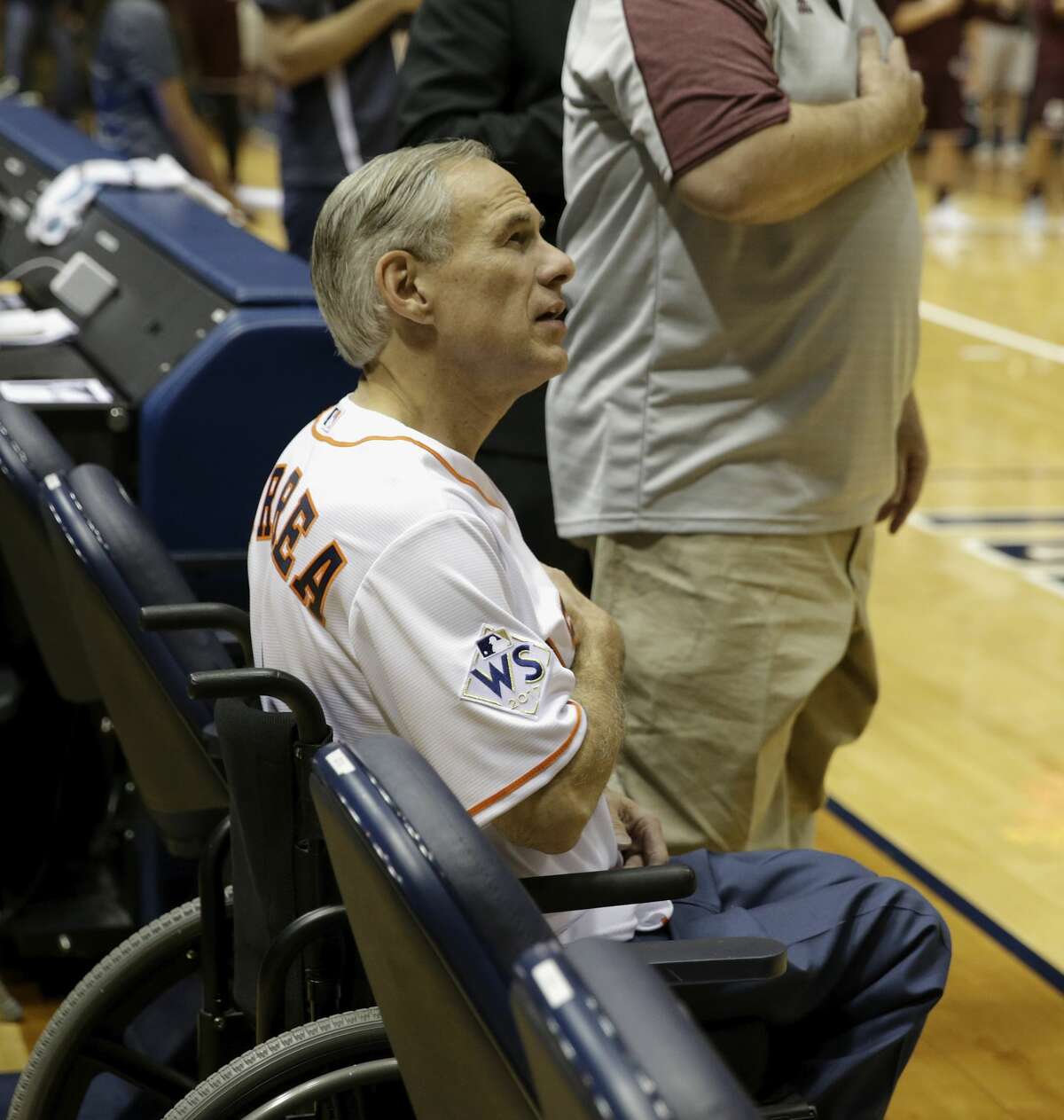 Texas Governor Greg Abbott sings during the National Anthem during the exhibition basketball game between the Texas Longhorns and the Texas A&M Aggies to benefit the Rebuild Texas Relief Fund at Tudor Fieldhouse in Houston, TX on Wednesday, October 25, 2017.