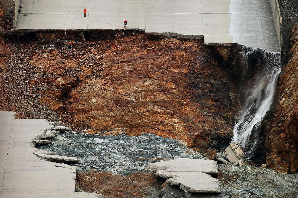 Officials inspect the damaged main spillway of the Oroville Dam on Friday, March 3, 2017, in Oroville, Calif.