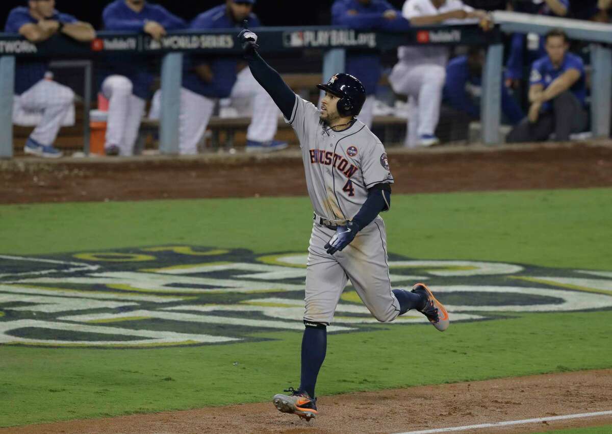 Houston Astros' George Springer celebrates after hitting a two-run home run during the 11th inning of Game 2 of baseball's World Series against the Los Angeles Dodgers Wednesday, Oct. 25, 2017, in Los Angeles. (AP Photo/Alex Gallardo)