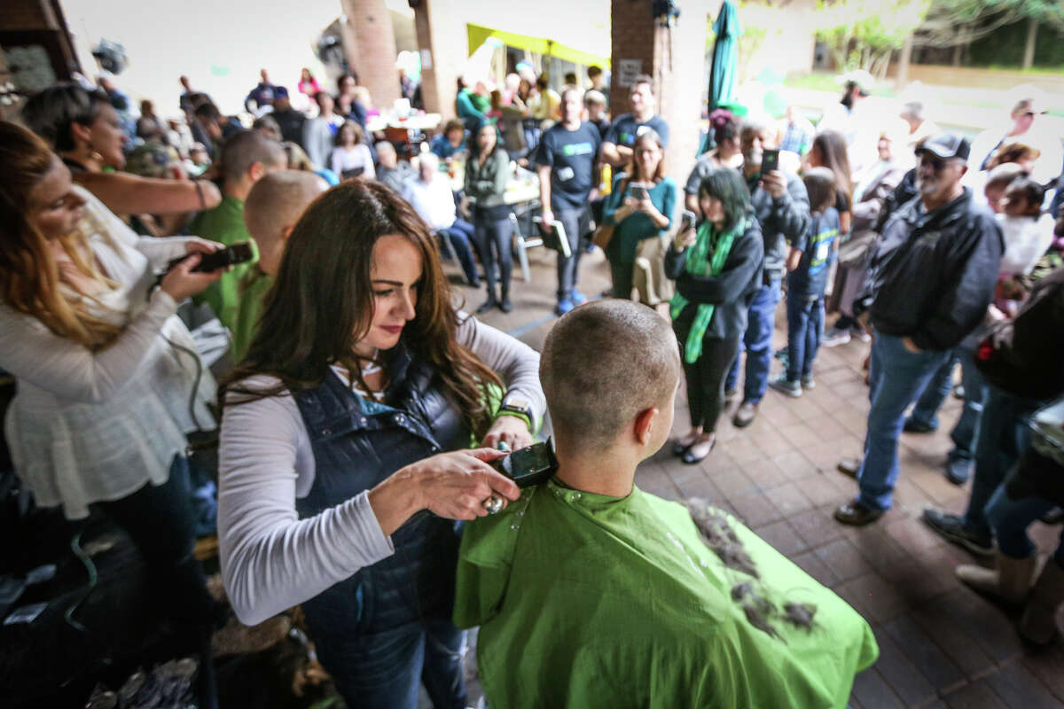 Jaci Chatham, of J. Hues Salon in Creekside, shaves a St. Balderick's participant's head on Sunday, March 12, 2017, at Goose's Acre in The Woodlands.