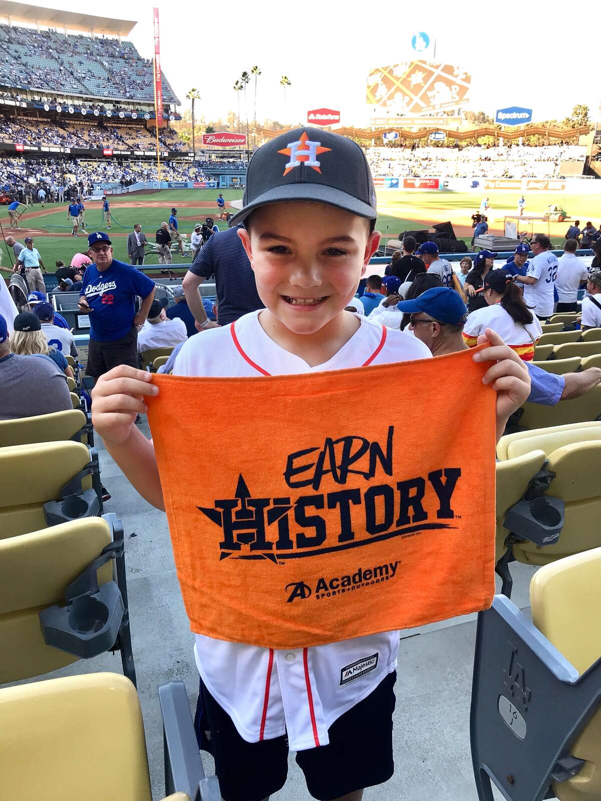 Houston Astros fans Rikki and Brian Kemp, of Nederland, and their son Chance, 8, traveled to Los Angeles for Games 1 and 2 of the World Series against the Dodgers. They met up with daughter, Logan, who moved to Los Angeles in January to work as a model for LA Models Agency. Here, Chance holds up a Houston Astros fan towel before the start of Game 2. (Photo provided by Rikki Kemp)
