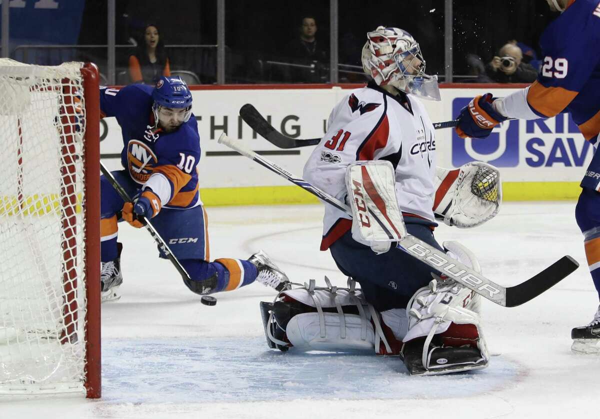 The Islanders’Alan Quine shoots the puck past WCapitals goalie Philipp Grubauer for a goal during the second period Jan. 31 in New York.