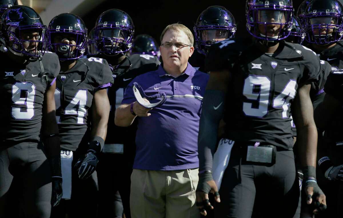 FILE - In this Oct. 1, 2016, file photo, TCU head coach Gary Patterson, center, stands with his players before an NCAA college football game against Oklahoma in Fort Worth, Texas. The Big 12 Conference has reached the midpoint of conference play with a tight race behind fourth-ranked TCU. While the Horned Frogs are the leagueÂ?’s only undefeated team, there is a four-way tie for second place among Top 25 teams. (AP Photo/LM Otero, File)