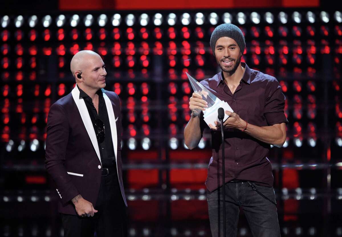Recording artists Pitbull (L) and Enrique Iglesias onstage during the 2017 Latin American Music Awards at Dolby Theatre on October 26, 2017 in Hollywood, California.