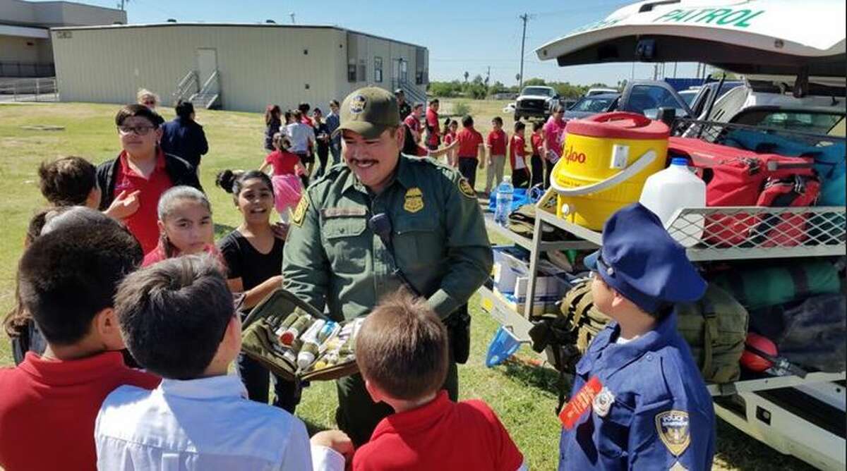 A U.S. Border Patrol agents showcases a kit used by EMTs to Harmony School of Innovation students on Thursday morning. Harmony put together a Careers on Wheels event and tied it in with Red Ribbon Week.