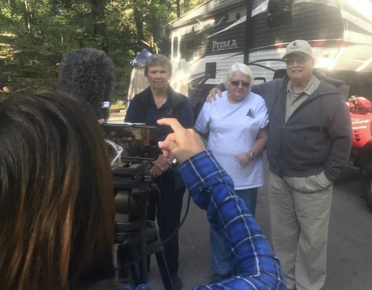 Student Cassandria Alvarado shoots video of Lincoln National Forest campground hosts Dennis (right) and Brenda Noska (middle) with campground area manager Pat Morris.