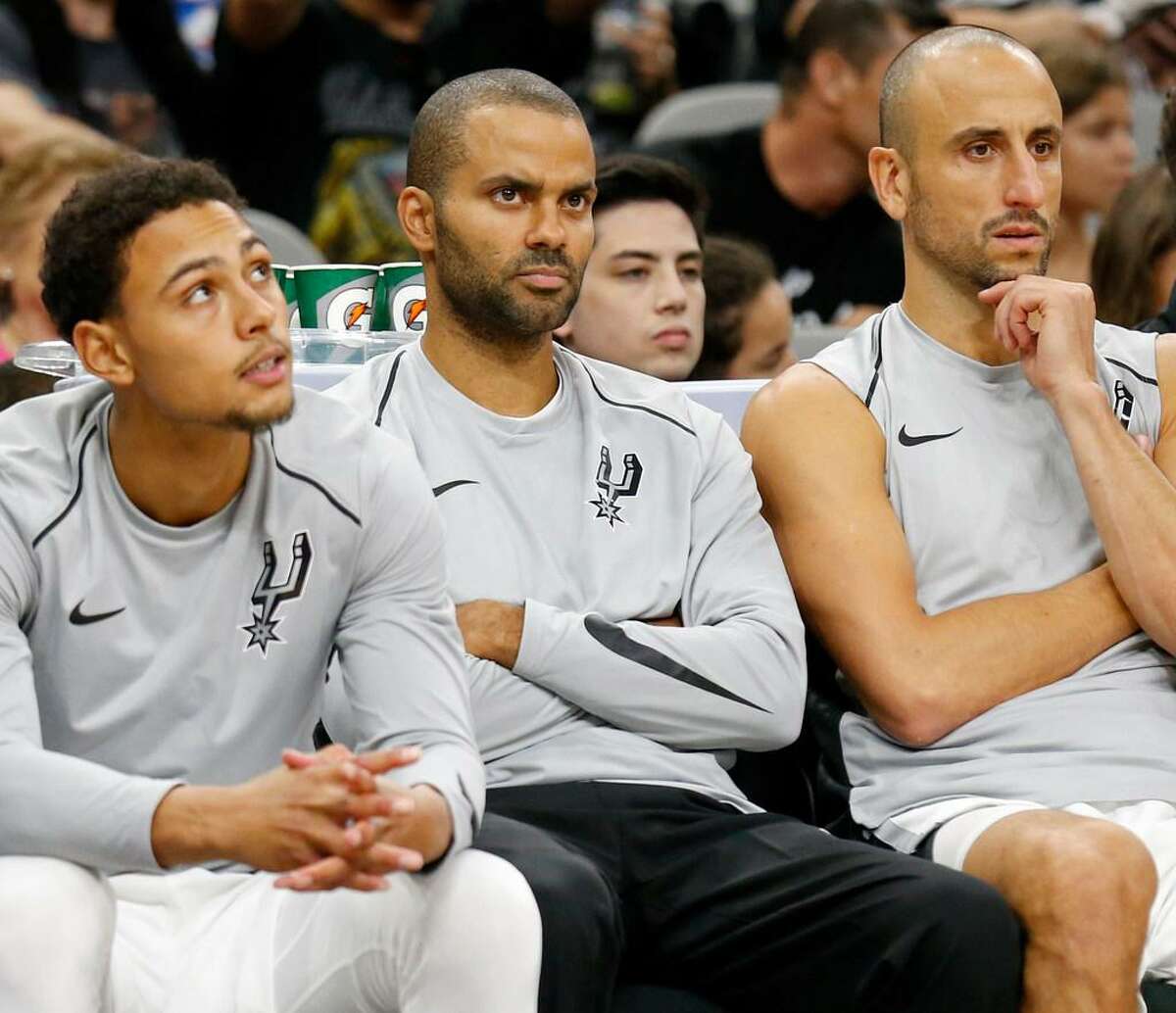 San Antonio Spurs’ Bryn Forbes (from left), Tony Parker, and Manu Ginobili watch first half action of their preseason against the Denver Nuggets from the bench Sunday Oct. 8, 2017 at the AT&T Center.