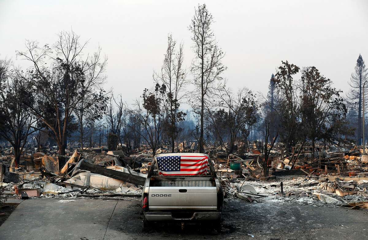 An American flag was placed inside the broken out back window of a burned out vehicle in the Coffey Park neighborhood, a week after the start of the massive fires in Santa Rosa, Ca. as seen on Monday October 16, 2017.