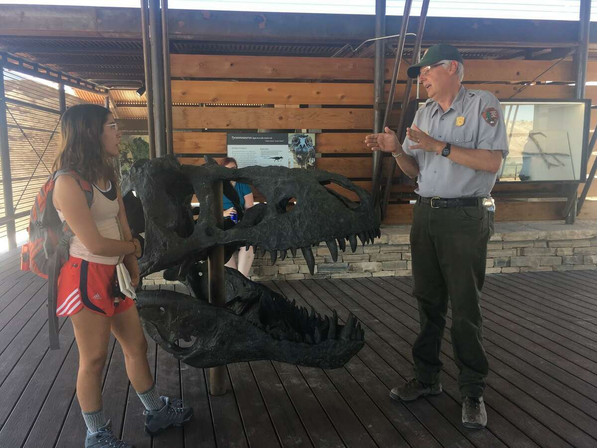 Big Bend National Park geologist Don Corrick (right) explains the replica T. Rex skull on display at the Fossil Discovery Exhibit to Texas State student Cassandria Alvarado.