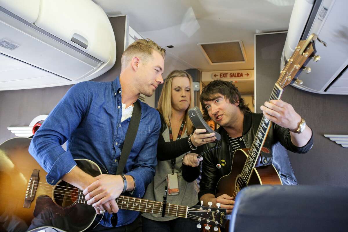 Tim Lopez (L) and Tom Higgenson (R) of Plain White T's perform in flight during the Live In The Vineyard 'Live At 35' Concert Series with Southwest Airlines on November 1, 2013 in Burbank, California.