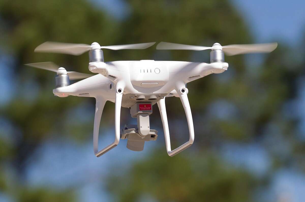 A DJI Phantom 4 quadcopter flies near Lake Conroe, Wednesday, Oct. 25, 2017, in Conroe. Drone System International donated the quadcopter and several remote pilot certification courses estimated at a combined $4,000 to the Montgomery County Precinct One Constable's Office Lake Patrol Division to aid in search and rescue efforts.