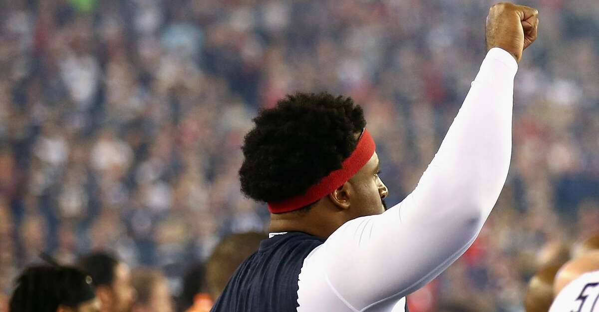 FOXBORO, MA - SEPTEMBER 22: Duane Brown #76 of the Houston Texans raises his fist during the national anthem before the game against the New England Patriots at Gillette Stadium on September 22, 2016 in Foxboro, Massachusetts. (Photo by Adam Glanzman/Getty Images)