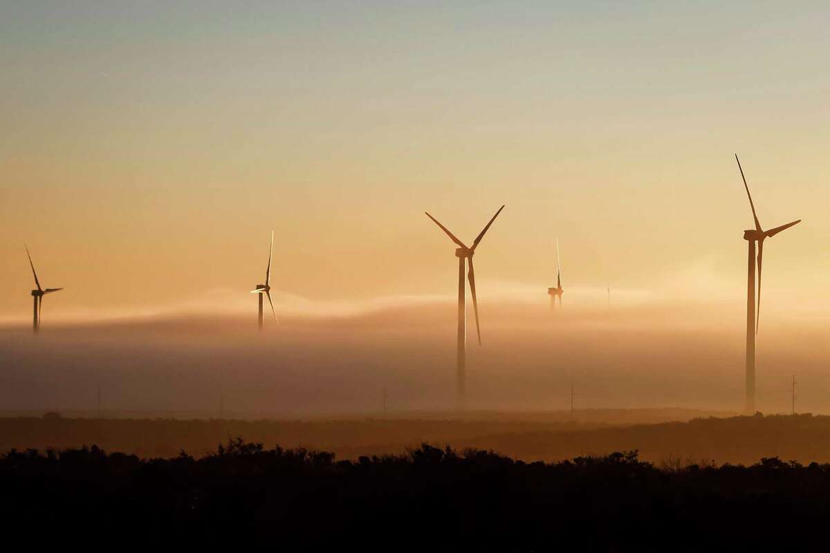 A thick cloud of fog and morning light engulfs several 285ft tall 2.5 MW Clipper wind turbines at the BP Sherbino Mesa II Wind Farm, Monday, Feb. 20, 2012, in Fort Stockton. After cutting its solar program last year, BP is beefing up its investments into wind energy and recently launched its fourth Texas wind farm, in Fort Stockton. On 20,000 acres in Pecos County, the Sherbino II farm has 60 wind turbines to generate enough electricity to power more than 175,000 homes. ( Michael Paulsen / Houston Chronicle )