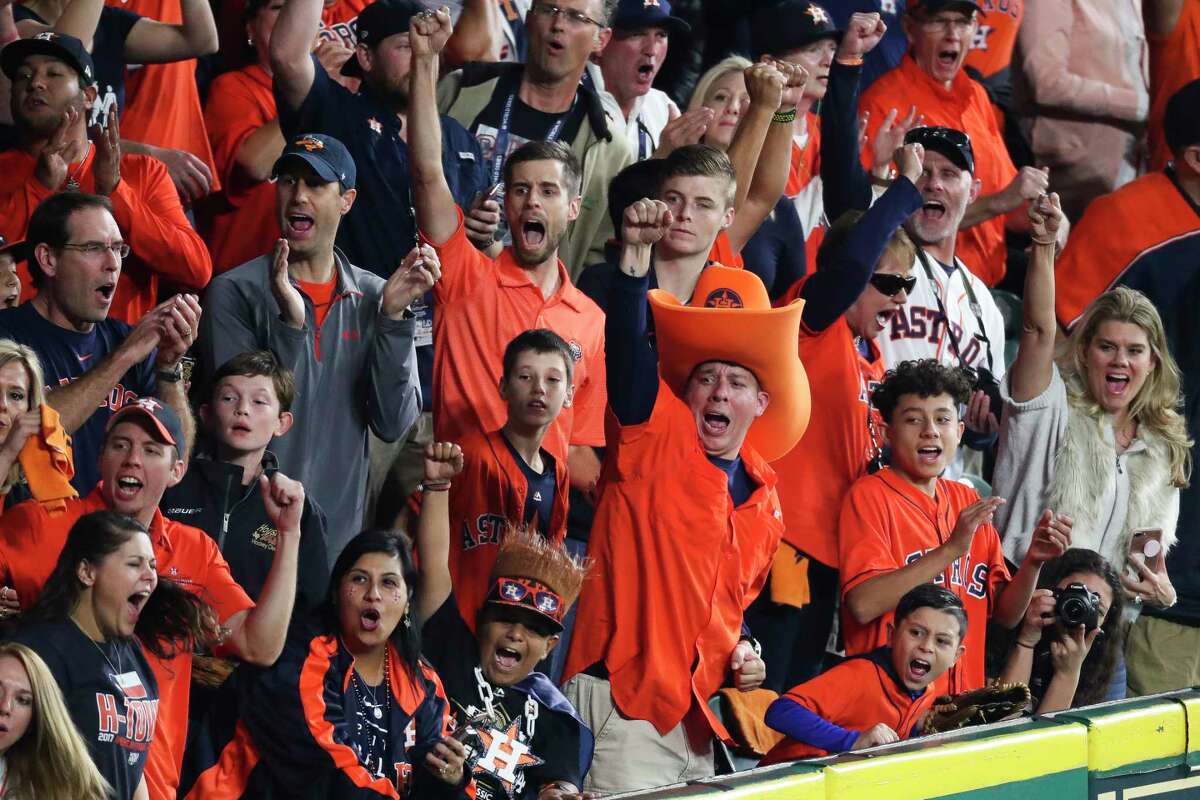 Fans whoop it up as Astros center fielder George Springer tracks down a long fly ball to end the top of the first inning of Game 3 on Friday night at Minute Maid Park. For complete coverage of Game 3, go to houstonchronicle.com/astros.