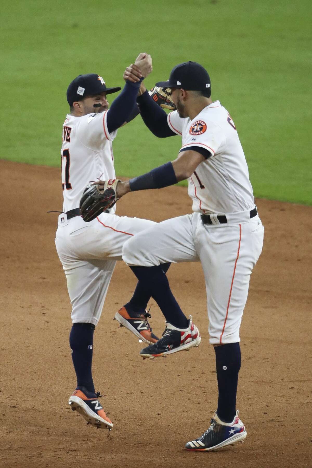 Houston Astros second baseman Jose Altuve (27) and shortstop Carlos Correa (1) celebrate as they beat the Los Angeles Dodgers 5-3 in Game 3 of the World Series at Minute Maid Park Friday, Oct. 27, 2017 in Houston.