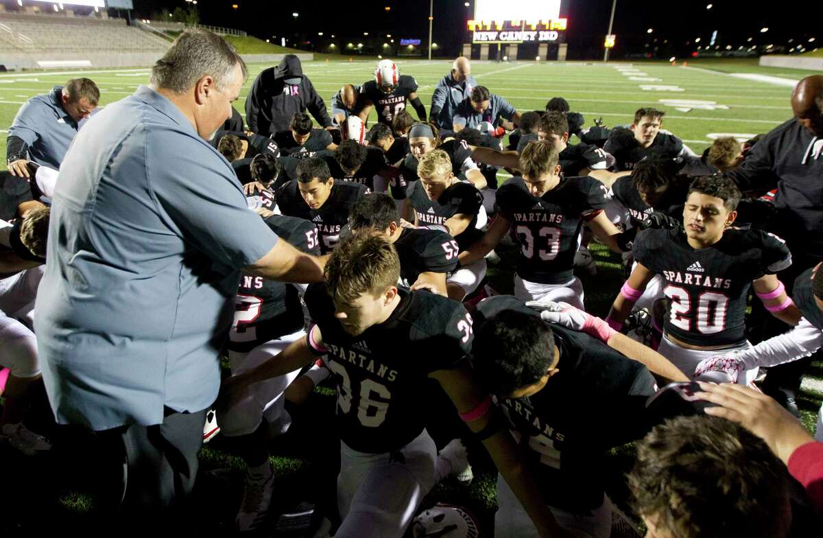 Porter players and coaches pray following the team's 28-13 District 21-5A win over Humble at Texan Drive Stadium, Friday, Oct. 27, 2017, in New Caney.