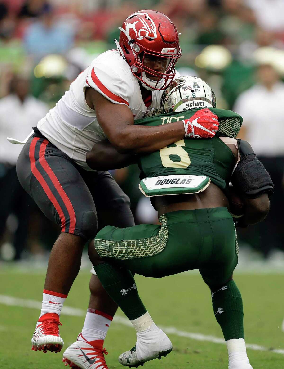 Houston defensive tackle Ed Oliver takes down South Florida running back Darius Tice (6) for a loss during the first half of an NCAA college football game, Saturday, Oct. 28, 2017, in Tampa, Fla. (AP Photo/Chris O'Meara)
