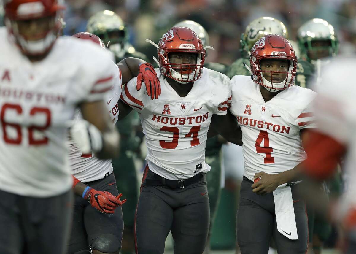 Houston running back Mulbah Car (34) ccelebrates with quarterback D'Eriq King (4) after scoring on a 4-yard touchdown run against South Florida during the second half of an NCAA college football game, Saturday, Oct. 28, 2017, in Tampa, Fla. Houston upset South Florida 28-24. (AP Photo/Chris O'Meara)