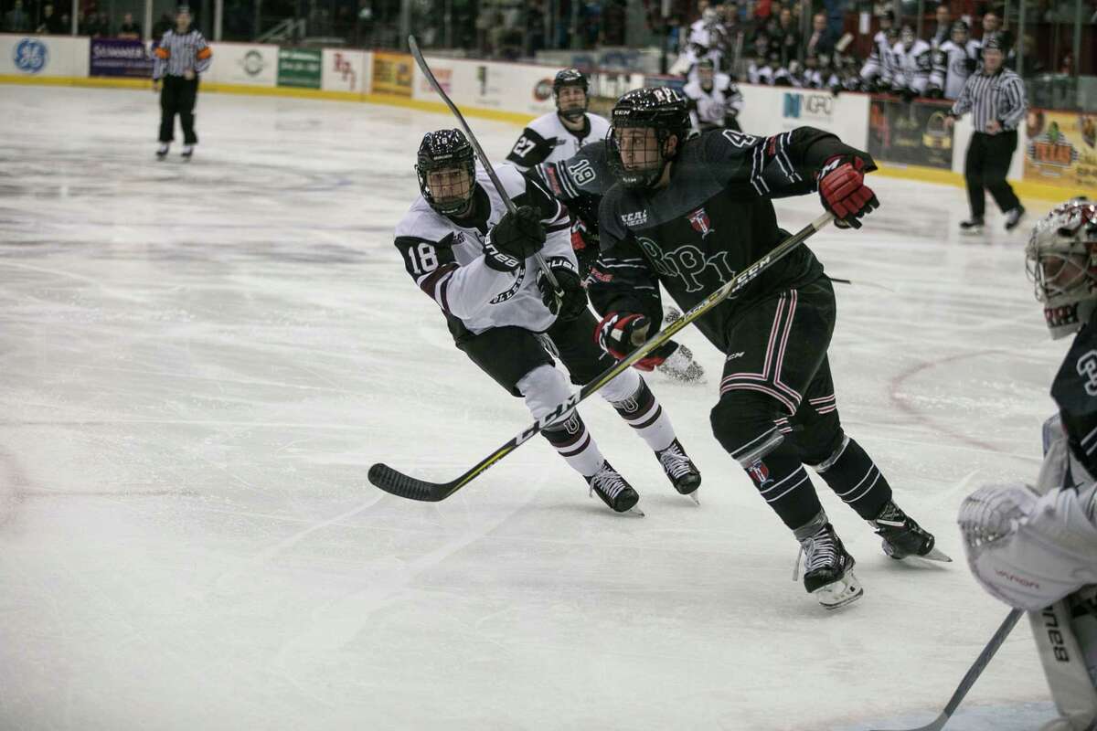 RPI Engineers TommyÊGrant (4) and Union College Dutchmen Brett Supinksi (18) fight for a loose puck at Houston Field House in Troy NY on October 28, 2017. (Photo: Robert Dungan, Special to the Times Union) ORG XMIT: MER2017082023255053