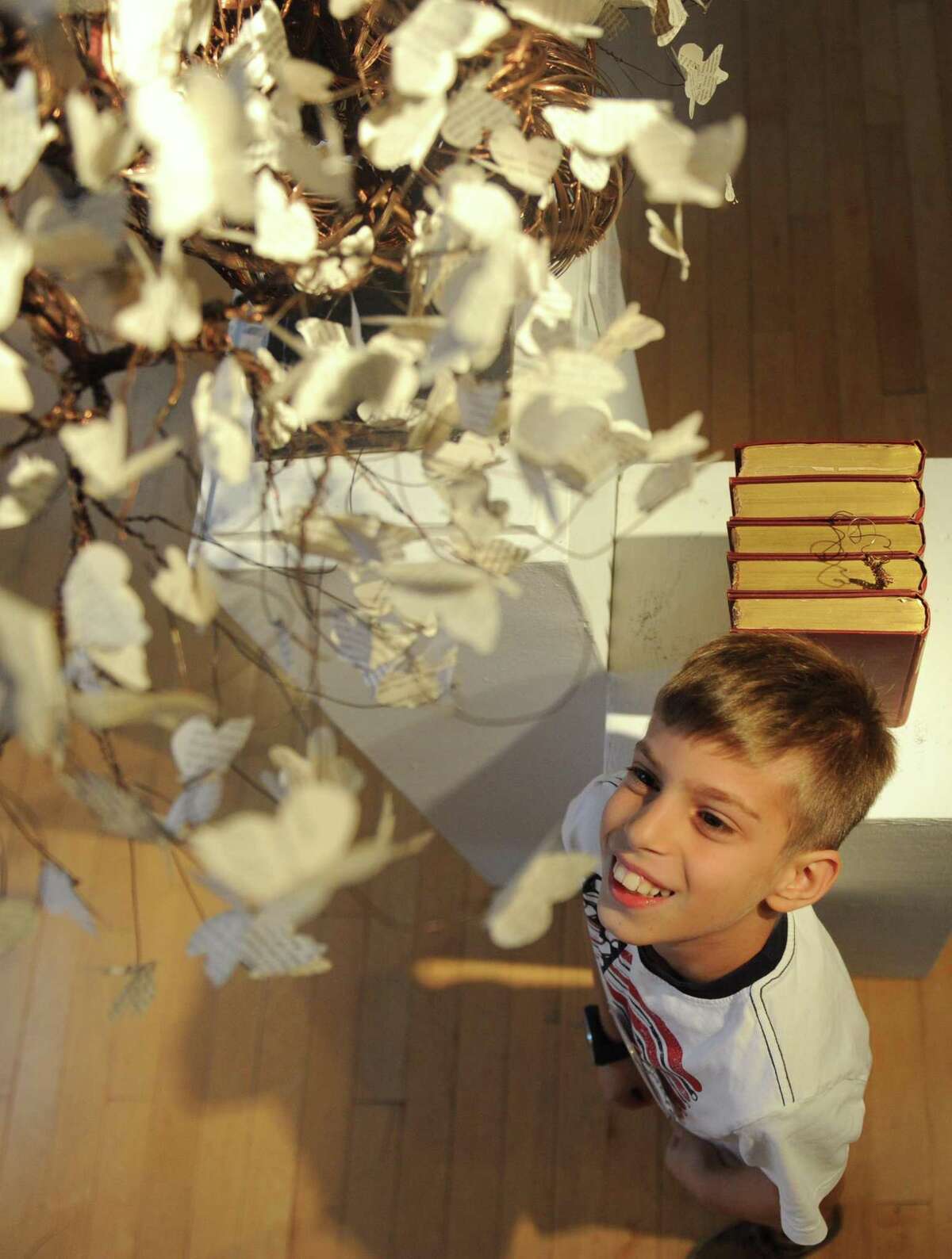 New Lebanon School fourth-grader Giorgi Kvatchanitiradze looks up at Max Neuman's installation piece "Anew" as part of the Youth@Art program at the Greenwich Arts Council's Bendheim Gallery in Greenwich, Conn. Wednesday, Oct. 25, 2017. The Bendheim Gallery's exhibition "Flower Stories" featuring contemporary artists' perception of flowers in a variety of mediums will run through Nov. 15.