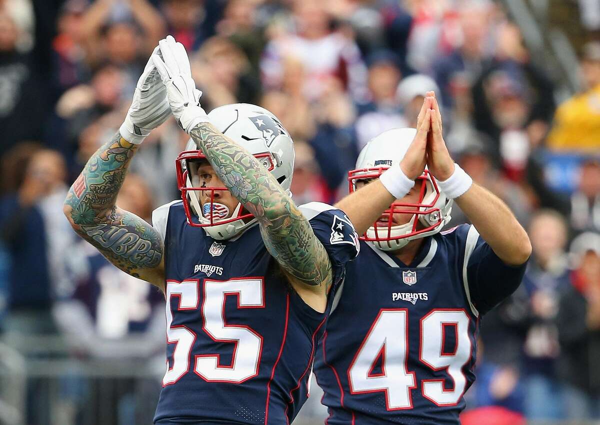 FOXBORO, MA - OCTOBER 29: Cassius Marsh #55 and Trevor Reilly #49 of the New England Patriots signal for a safety during the second quarter of a game against the Los Angeles Chargers at Gillette Stadium on October 29, 2017 in Foxboro, Massachusetts. (Photo by Maddie Meyer/Getty Images)