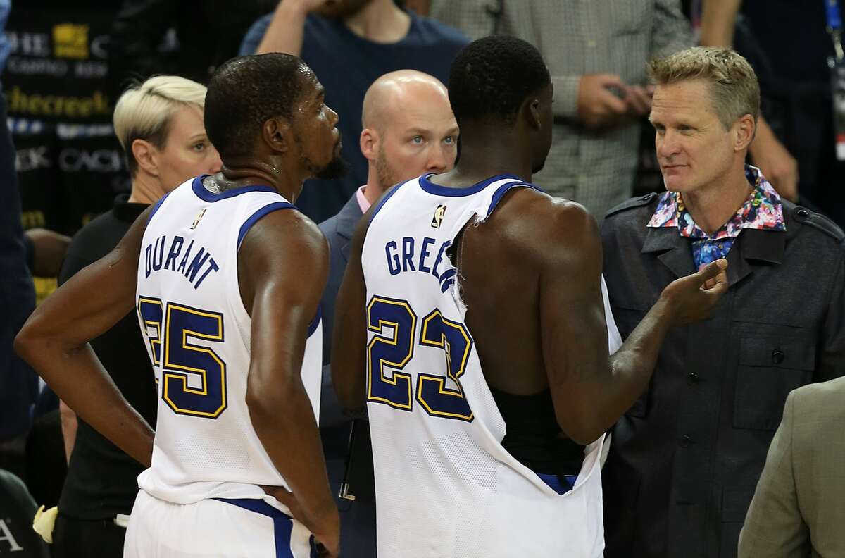 Golden State Warriors coach Steve Kerr talks with Draymond Green (23) following his ejection for a scuffle as Kevin Durant (35) looks on during the Golden State Warriors game versus the Washington Wizards on October 27, 2017 at Oracle Arena in Oakland, California.