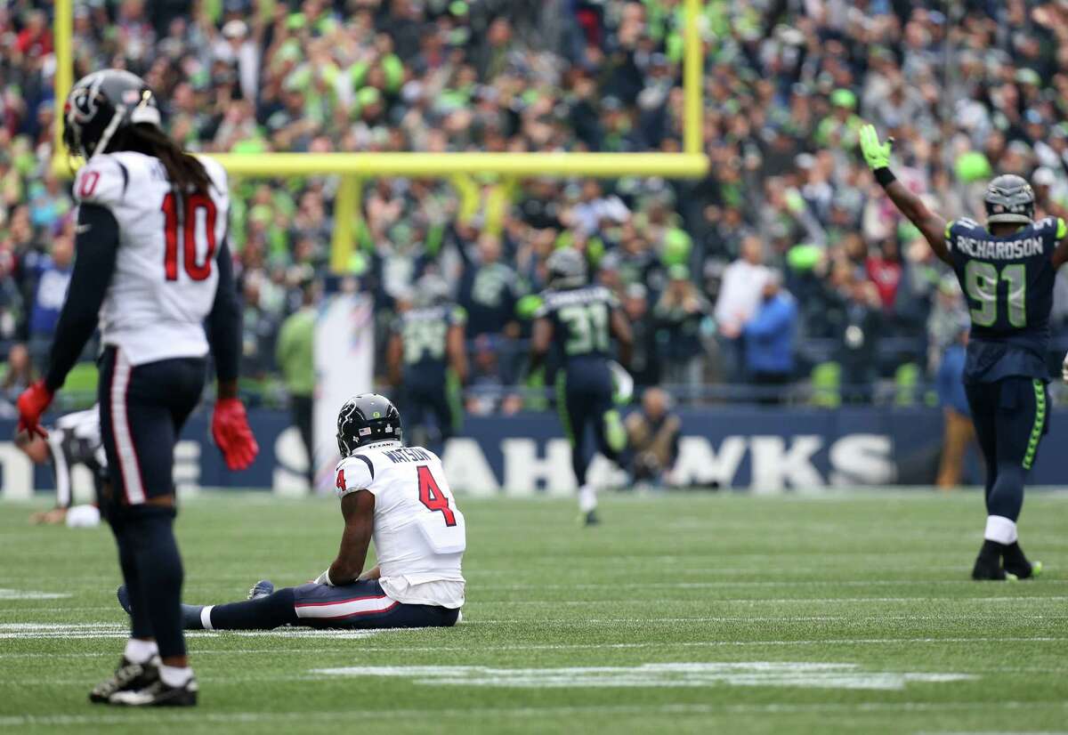 Houston Texans quarterback Deshaun Watson (4) watches as Seattle Seahawks free safety Earl Thomas (29) scores a touchdown off an interception during the first half of the game at CenturyLink Field Sunday, Oct. 29, 2017, in Seattle.